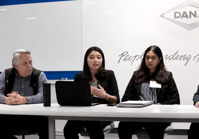 a panel on a stage actively answering a question